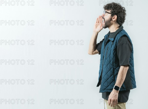 Male person shouting an announcement isolated. Casual young man in glasses shouting a promotion