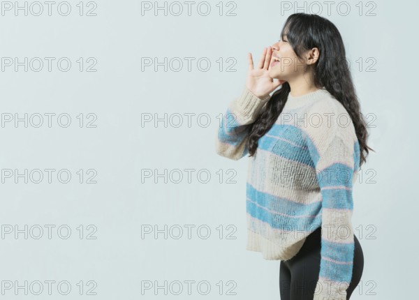 Young asian woman shouting an announcement. Beautiful asian girl shouting a promotion isolated