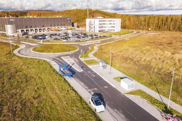 Modern architecture with street, parking lot and surrounding autumn landscape, new Lindenrain industrial park, Calw, Black Forest, Germany