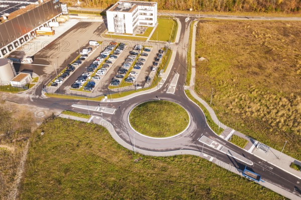 Roundabout and buildings in an autumn environment from the air, new Lindenrain industrial park, Calw, Black Forest, Germany
