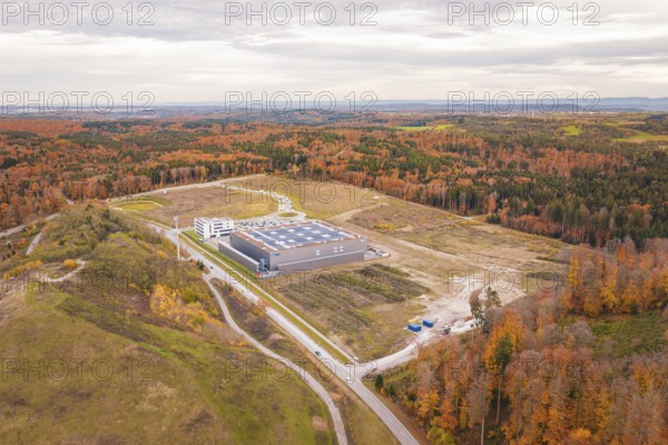 Large industrial area surrounded by autumn forests and vast landscapes, new Lindenrain industrial park, Calw, Black Forest, Germany