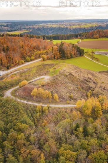 Panoramic view of autumn hills with colorful foliage, new Lindenrain industrial park, Calw, Black Forest, Germany