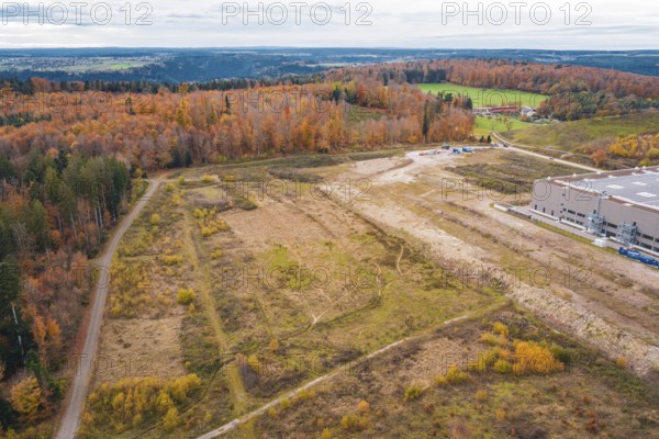 Extensive meadows and autumn forest on a country road, peaceful landscape, new Lindenrain industrial park, Calw, Black Forest, Germany