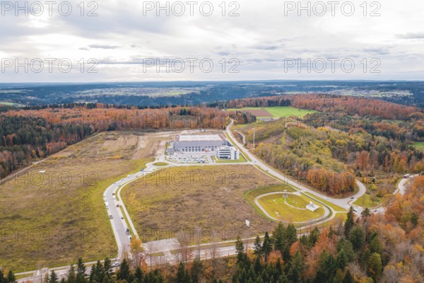 Large industrial area surrounded by forests and roads in an autumnal atmosphere, new Lindenrain industrial park, Calw, Black Forest, Germany