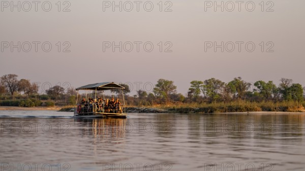 Boat trip, tourists in a boat on the Okavango River, Caprivi Strip, Namibia