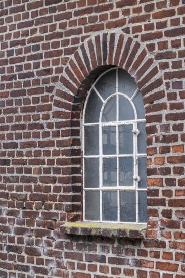 Old brick wall with an arched window and a rustic architectural style, Düstermühle, Münsterland, North Rhine-Westphalia, Germany