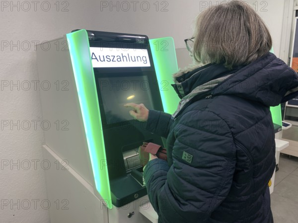 Elderly woman at an EC cash machine, operates screen, has money withdrawn, BW-Bank, Baden-Württembergische Bank, Bad Cannstatt, Stuttgart, Baden-Württemberg, Germany