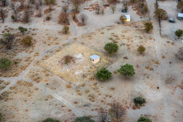 Settlement, simple house and fence, dry savanna landscape, near Maun, aerial view, Okavango Delta, Botswana