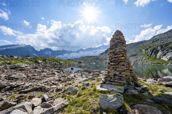 Steinmännchen am See mountain lake, picturesque mountain landscape with dammastock and damma glacier, Göscheneralp, Canton of Uri, Switzerland