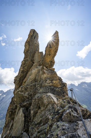Crocodile rock formation with sun star, via ferrata Krokodil-Bergsee am Bergseeschijen-Vorbau, Göscheneralp, Canton of Uri, Switzerland