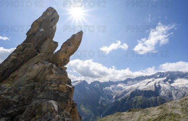 Crocodile rock formation with sun star, view of dam glaciers and dammastock, via ferrata crocodile mountain lake at Bergseeschijen-Vorbau, Göscheneralp, Canton of Uri, Switzerland