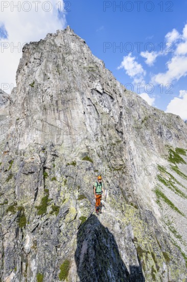 Mountaineers on the secure via ferrata Crocodile Mountain Lake at Bergseeschijen-Vorbau, Göscheneralp, Canton of Uri, Switzerland