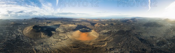 Panorama, Montaña Negra volcano and Caldera Colorada, picturesque volcanic landscape with volcanic crater in morning light, Parque Natural de Los Volcanes, aerial view, Lanzarote, Canary Islands, Spain