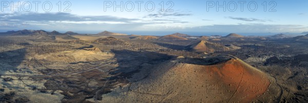 Panorama, Caldera Colorada volcano and Volcán de Las Nueces, picturesque volcanic landscape with volcanic craters in morning light, Parque Natural de Los Volcanes, aerial view, Lanzarote, Canary Islands, Spain
