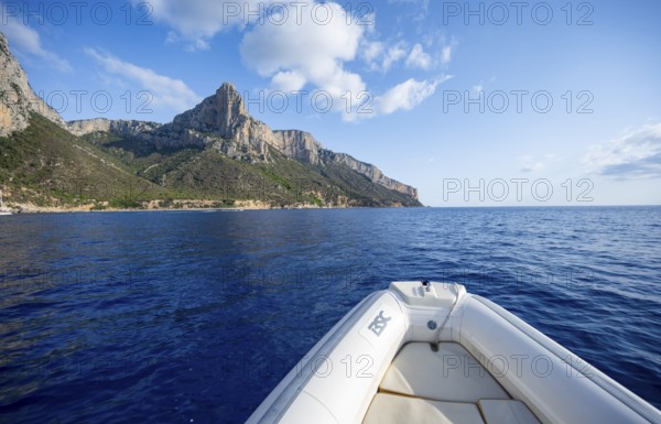 Motorboat trip along the picturesque rocky coast, cliffs and blue sea, Golfo di Orosei, Baunei, Sardinia, Italy