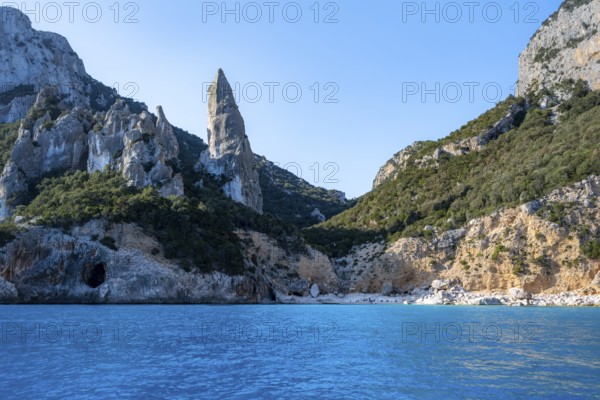 Picturesque rocky coast, cliffs with L'Aguglia pinnacle, blue sea and Cala Goloritzé beach, Golfo di Orosei, Baunei, Sardinia, Italy