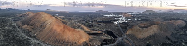 Picturesque volcanic landscape with volcanic craters Montaña de la Tabaiba and Montaña Corujo at sunrise, Parque Natural de Los Volcanes, aerial view, Lanzarote, Canary Islands, Spain