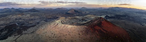 Panorama, Caldera Colorada volcano, picturesque volcanic landscape with volcanic craters at sunrise, Los Volcanes Natural Park, aerial view, Lanzarote, Canary Islands, Spain