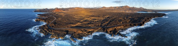 Coast with lava fields, volcanic landscape near Los Hervideros with red volcano Montaña Bermeja, in the evening light, aerial view, Lanzarote, Canary Islands, Spain