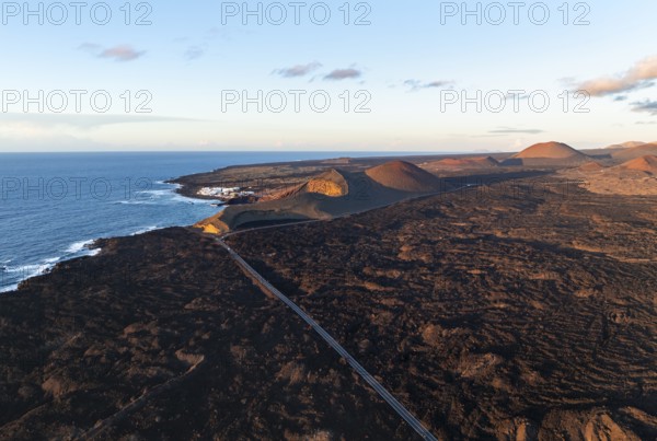 Coast with lava fields near Charco Verde, volcanic landscape in evening light, aerial view, Lanzarote, Canary Islands, Spain