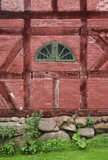 Green window in a wall in a red half-timbered house in Den gamle by, The old Funen village, open air museum in Odense, Fyn island, Funen, Denmark, Scandinavia