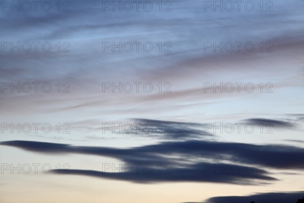 Pastel-coloured cloud formations in the evening sky, Peenetal nature park Park, Mecklenburg-Western Pomerania, Germany