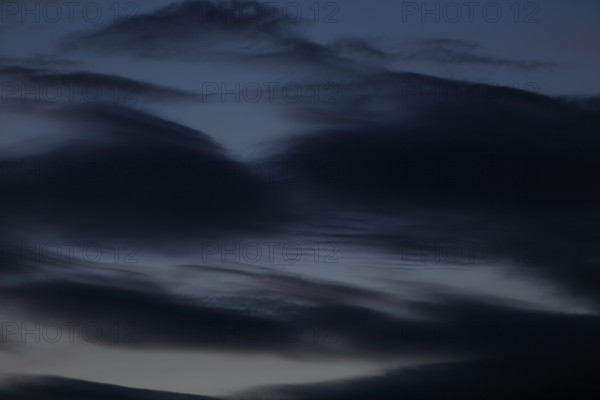 Dark clouds sweep across the sky at dusk, Peenetal nature park Park, Mecklenburg-Western Pomerania, Germany