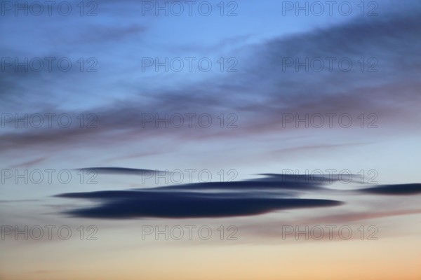 Colourful clouds spread over a blue-orange sunset sky and appear peaceful, Peenetal nature park Park, Mecklenburg-Western Pomerania, Germany