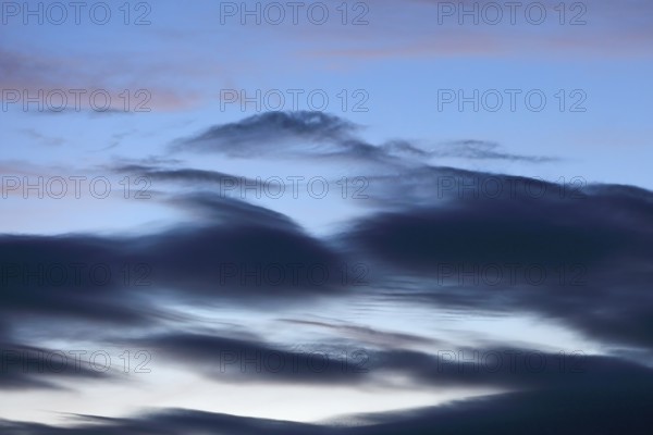 Blue sky with dramatic dark clouds at dusk, Peenetal nature park Park, Mecklenburg-Western Pomerania, Germany