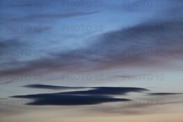 Soft shades of blue and pastel clouds at dusk, Peenetal nature park Park, Mecklenburg-Western Pomerania, Germany