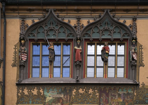 Painted façade with 5 medieval human sculptures, fresco cycle, window, town hall, old town, Ulm, Baden-Württemberg, Germany