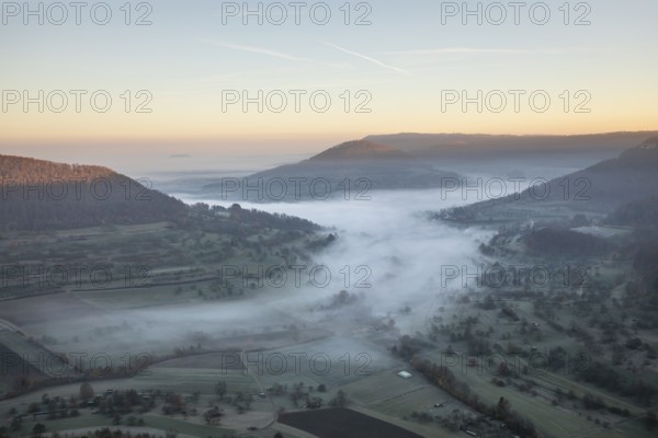 View of the foggy Neidlinger Valley in autumn at sunrise, Swabian Alb