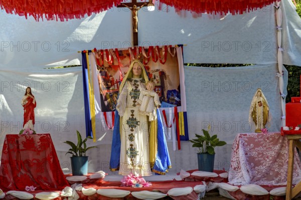 Colorful altar decorated with images of Catholic saints and the Virgin Mary