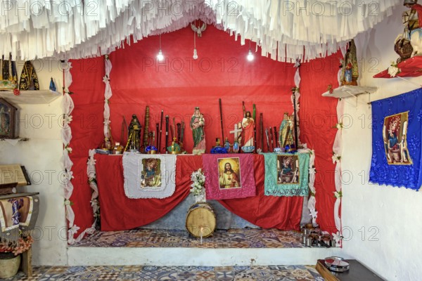 Altar in the interior of Brazil with objects, images of saints and entities from different religions