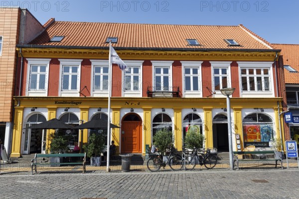 Building with bakery and outdoor seating, square in the old town of Rønne, Bornholm Island, Denmark