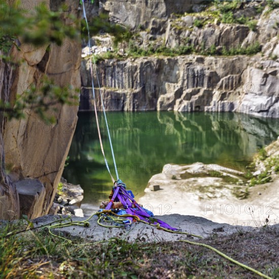 Ropes, slings and carabiners secured on a rock edge, opal lake in the granite quarry, Moselleøkken Stenbrudsmuseum, museum in the quarry, Hammerknuden, Allinge-Sandvig, Bornholm, Denmark