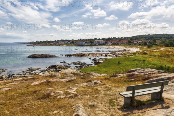 Reddish shimmering granite rocks, sandy bottom, wooden bench, Sandvig Strand, coastline, Hammerknuden, Allinge, Bornholm, Denmark