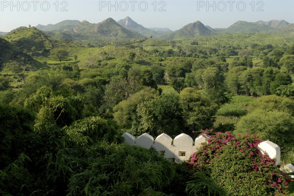 Hilly, green landscape of Aravalli Mountains in monsoon, view from Palace Hotel Devigarh, Delwara village near Udaipur, Rajasthan, India