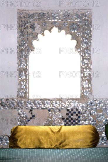A window decorated with mirrors, including a cushion covered with shiny gold fabric, Karni Fort Bambora Palace Hotel, Bambora, Rajasthan, India