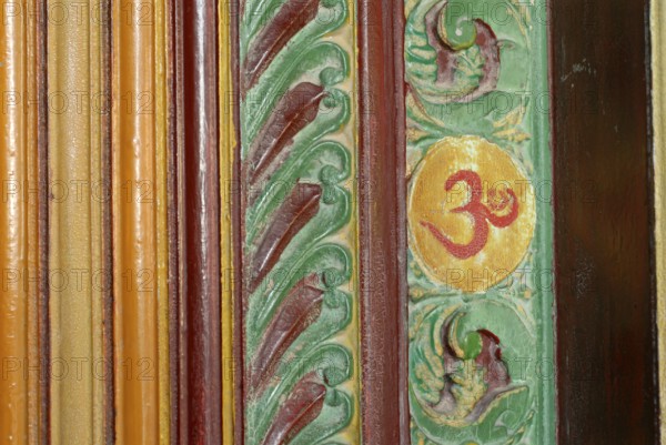 Painted wood carving, Om sign, Kalari Kovilakom, Ayurveda Palace of the Cgh-Earth Hotel Group, Kollengode, Vengunad, Kerala, India