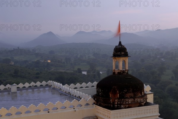 Hilly landscape of Aravalli Mountains in soft twilight, monsoon atmosphere, Devigarh Palace Hotel, Delwara village near Udaipur, Rajasthan, India
