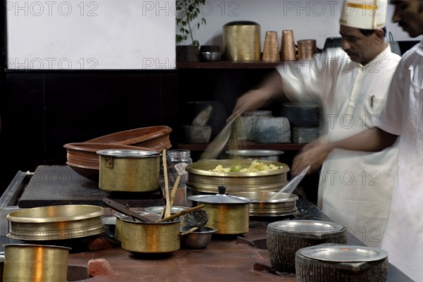 Chefs work in a traditional Tamil kitchen, copper pots and intensive cooking activity, Villa Visalam, Cgh-Earth Hotel Group Hotel, Kanadukathan, Chettinad, Tamil Nadu, India