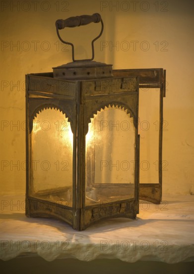 Antique metal lantern with warm light, rustic charm, Karni Fort Bambora Palace Hotel, Bambora, Rajasthan, India