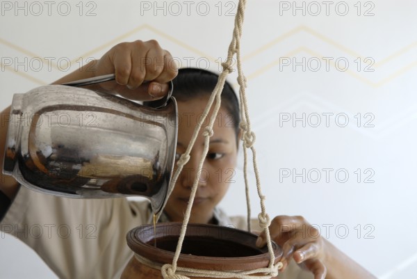 Forehead oil effusion or Shirodhara Ayurveda treatment with sesame oil at the spa, Udaipur, Rajasthan, India