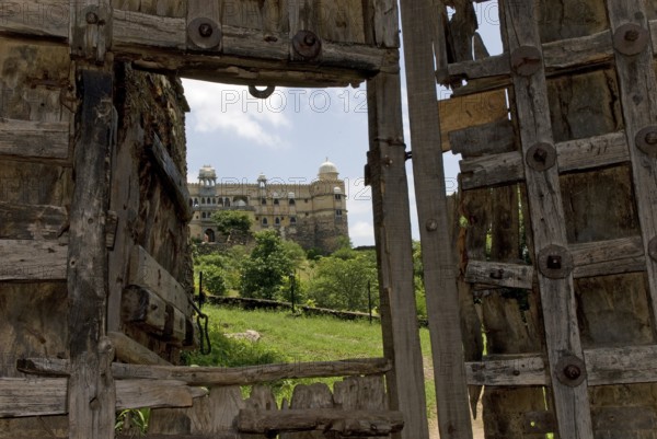 Old, heavily fortified wooden gate, Palasthotel Karni Fort Bambora entrance, Bambora, Rajasthan, India