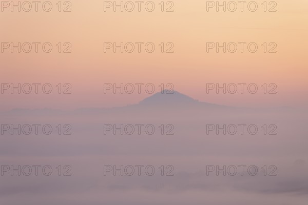 Hohenstaufen mountain in golden morning light, Aichelberg. Spectacular dawn over the foggy foothills of Alb