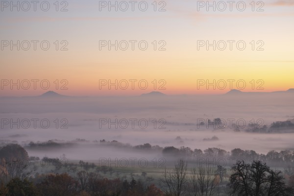 Three Kaiserberge mountains in golden morning light, Hohenstaufen, Aichelberg. Spectacular dawn over the foggy foothills of Baden-Württemberg