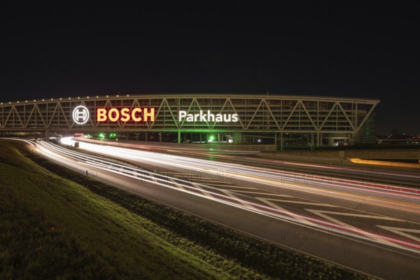 Night view of the A8 with traces of light at the P20 Messe car park, Airport, Stuttgart Germany
