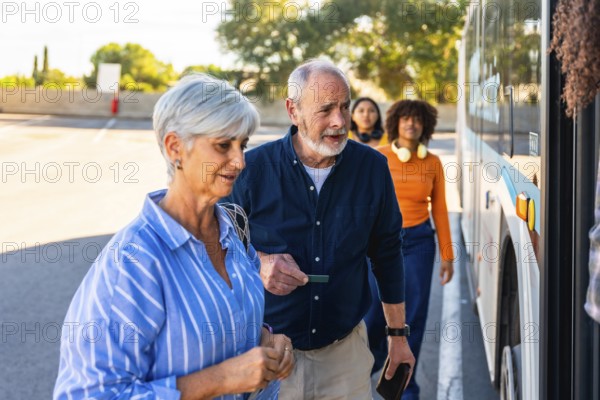 Senior couple approaching a bus entrance, showing a man holding a ticket while waiting in line with other diverse passengers for public transportation