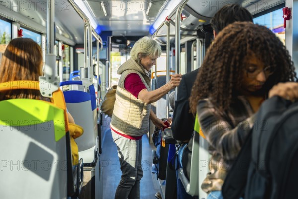 Senior woman standing inside a crowded city bus, holding a handrail among diverse commuters during rush hour urban transit, daily commute and public transportation scene